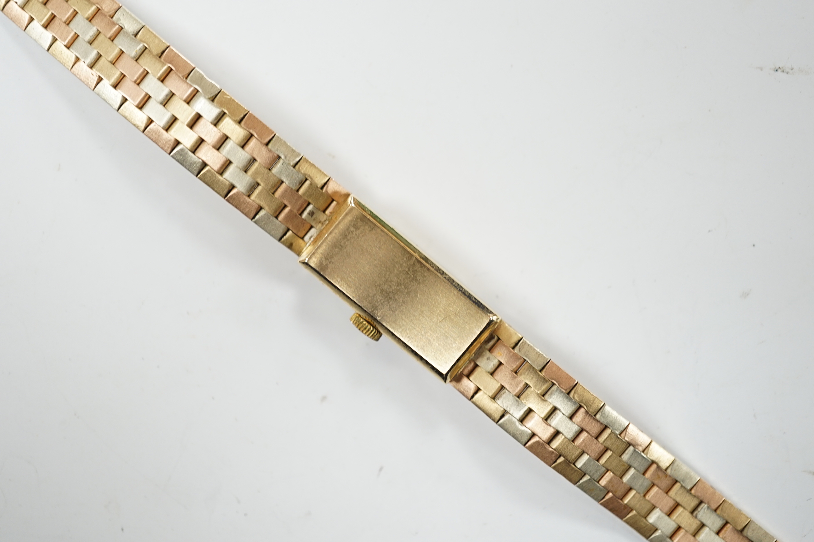 A lady's 9ct three colour gold Beuche Girod manual wind bracelet wrist watch, overall 16.7cm, gross weight 30.1 grams.